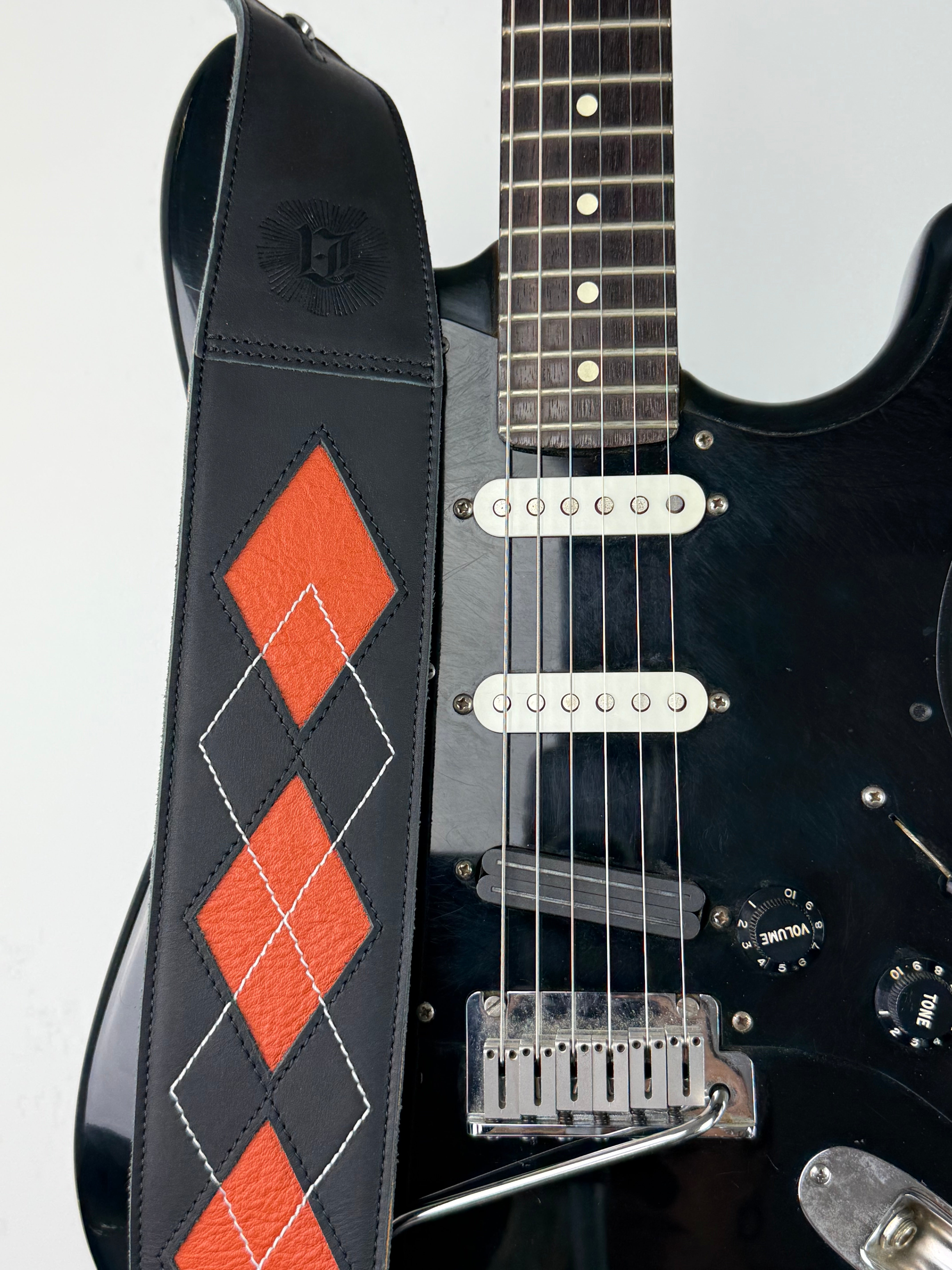 Everett - Carbon Black/Orange Peel Argyle Leather Guitar Strap